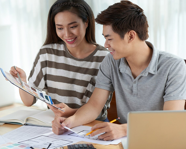 Asian woman sharing creative ideas with a colleague at the office